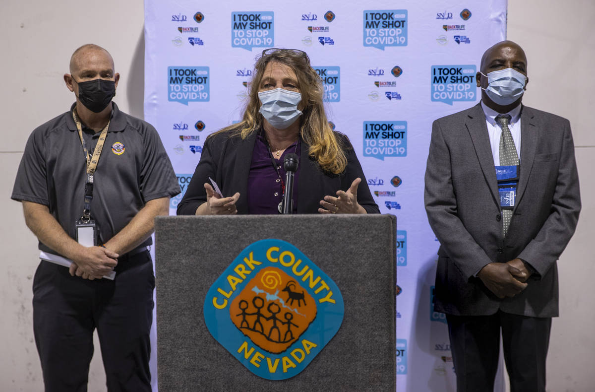 Commissioner Marilyn Kirkpatrick, center, with Chief Greg Cassell, left, and Dr. Fermin Leguen ...