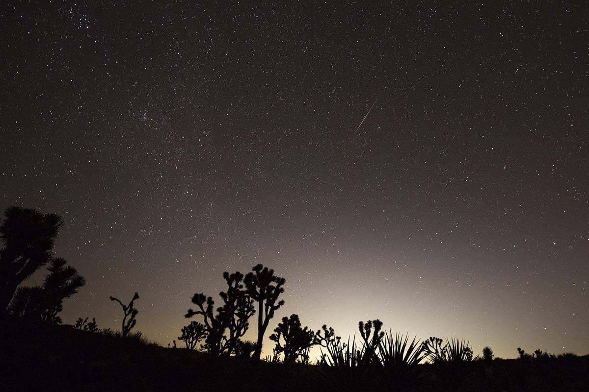 Las Vegas glows in the distance as a meteor streaks above the Mojave Desert before dawn in 2018 ...