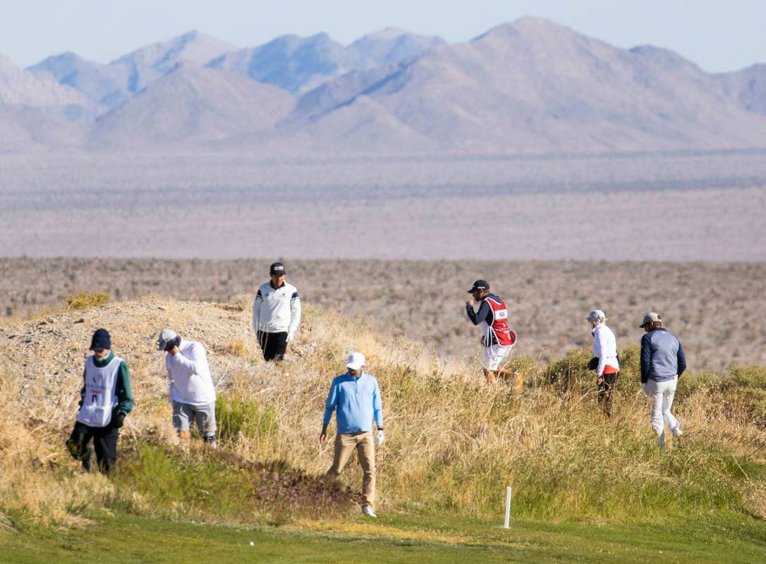 Triple-A golfers and their caddies search for a lost golfball during the first round of the MGM ...