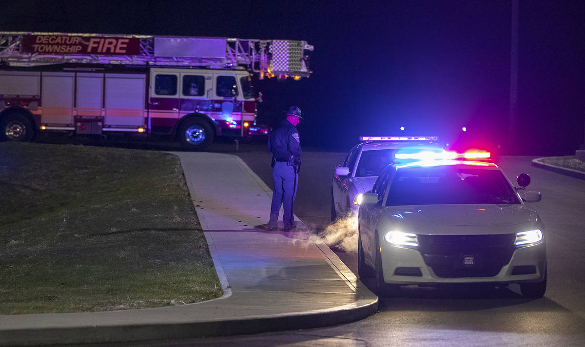 Police and fire teams arrive at the scene outside a FedEx facility in Indianapolis where multip ...