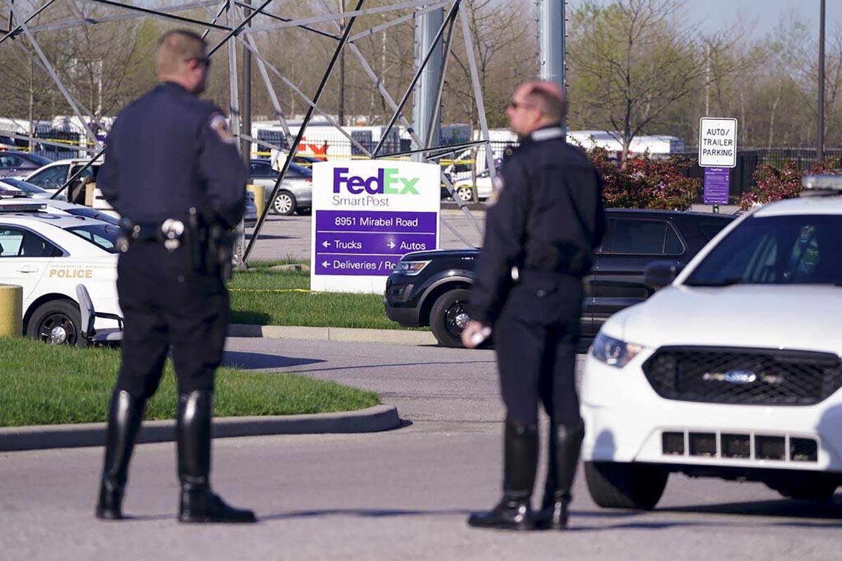 Police stand near the scene where multiple people were shot at the FedEx Ground facility early ...