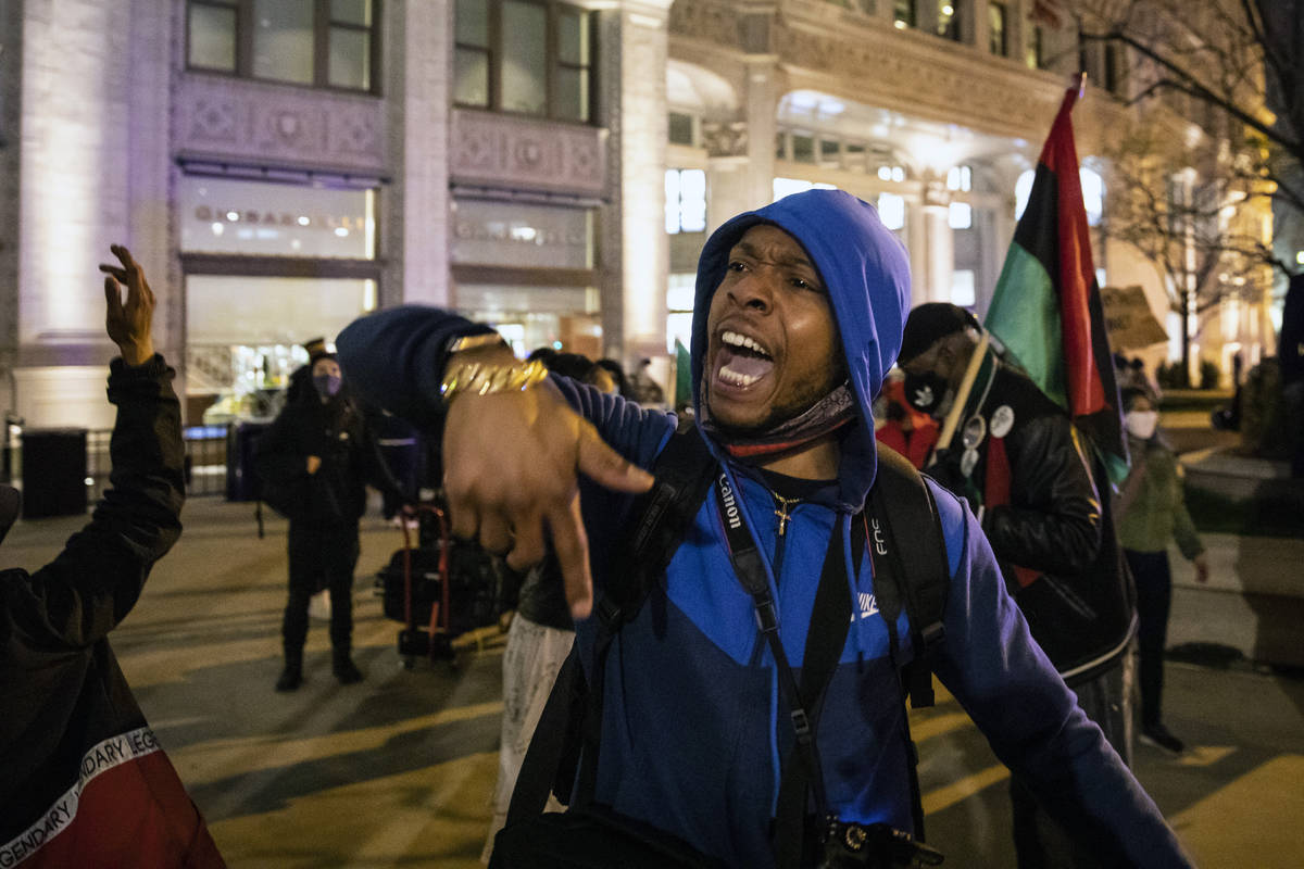 Lamon Reccord leads a chant as dozens of protesters march down the Magnificent Mile after the c ...