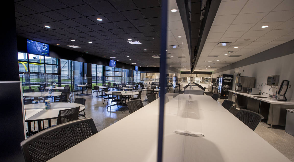 A full cafeteria overlooks the indoor practice field within the Las Vegas Raiders headquarters ...