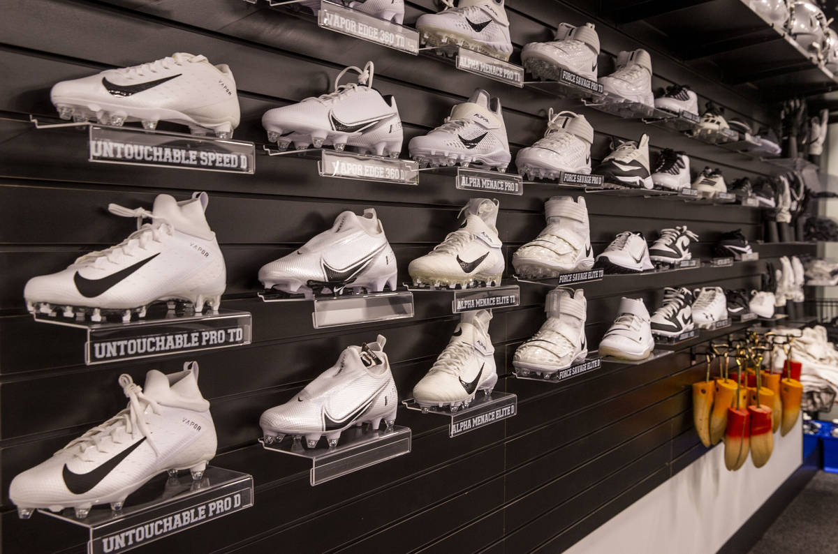 A rack of possible athletic shoe choices for players hangs in the equipment room within the Las ...
