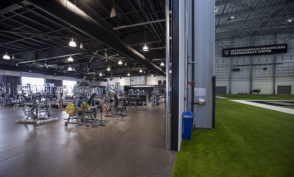 A large weight room opens to the indoor practice field within the Las Vegas Raiders headquarter ...