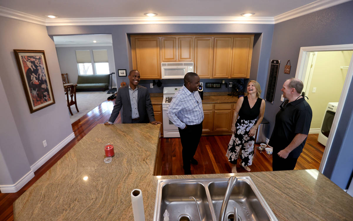 Realtor Shawn Cunningham, second from left, and his brother Kyle Cunningham, left, show a Las V ...
