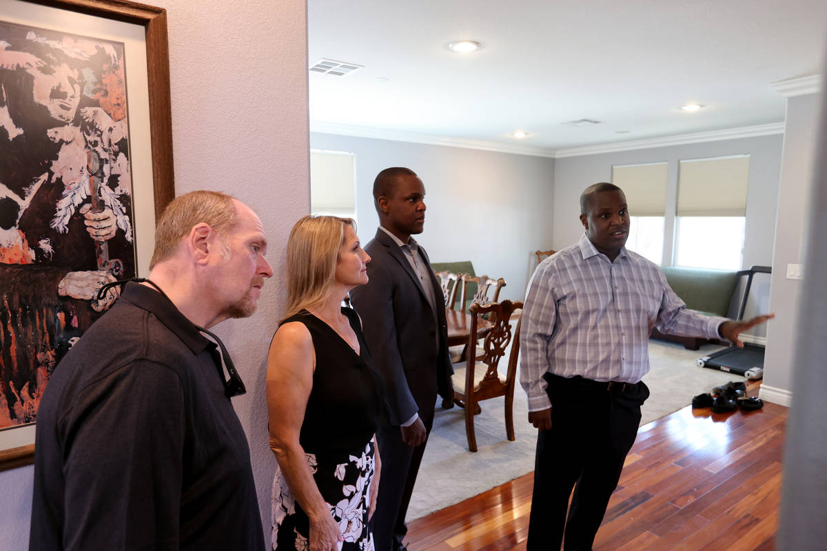 Realtor Shawn Cunningham, right, and his brother Kyle Cunningham, second from right, show a Las ...