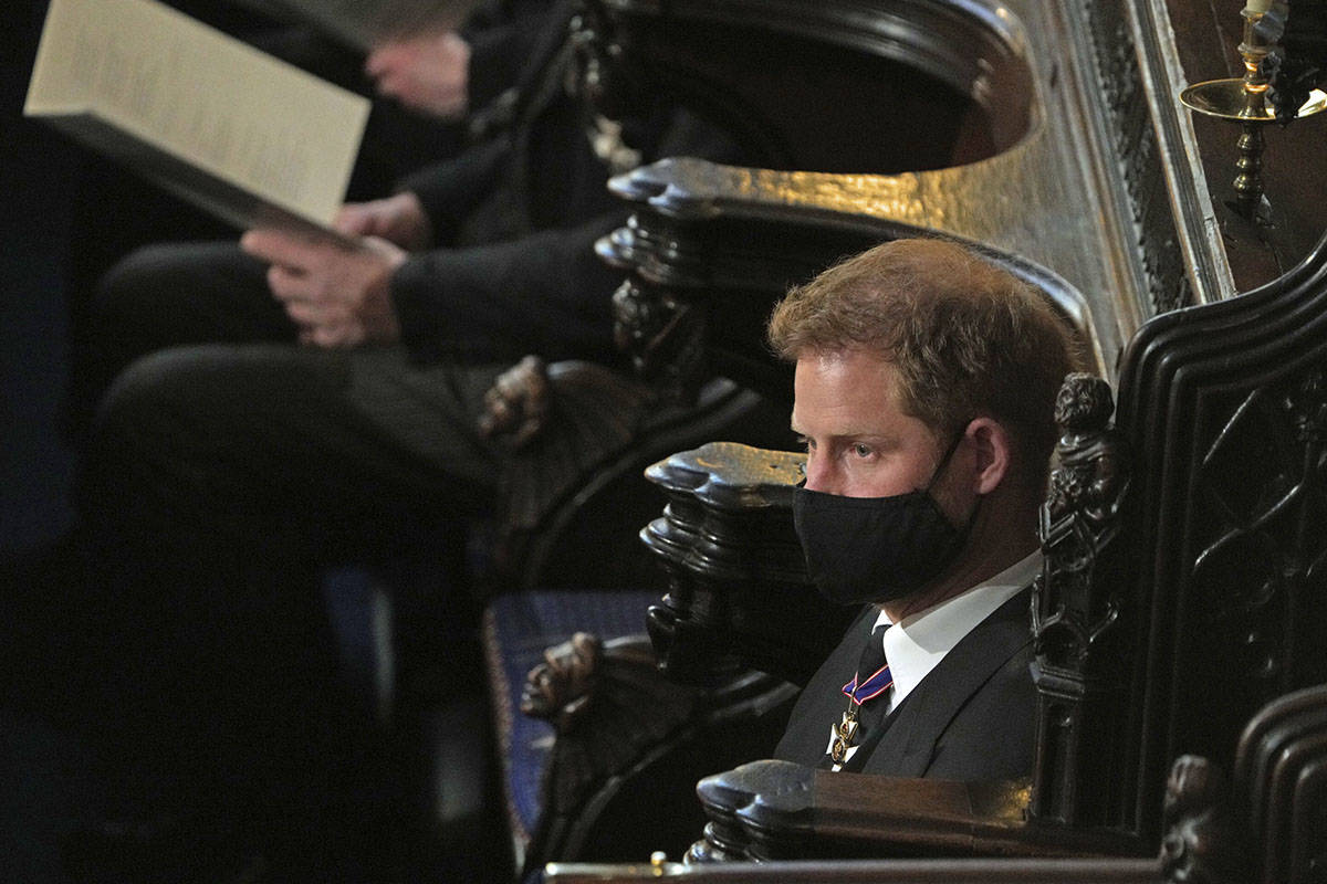 Prince Harry sits alone at St. George’s Chapel during the funeral of Prince Philip, at W ...