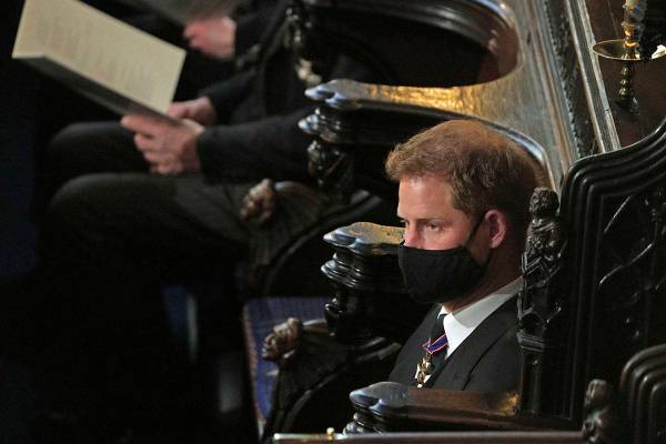 Prince Harry sits alone at St. George’s Chapel during the funeral of Prince Philip, at W ...