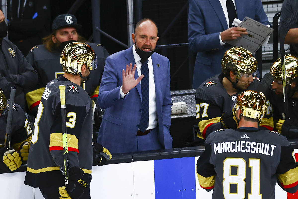 Golden Knights head coach Pete DeBoer talks with his team during the third period of an NHL hoc ...
