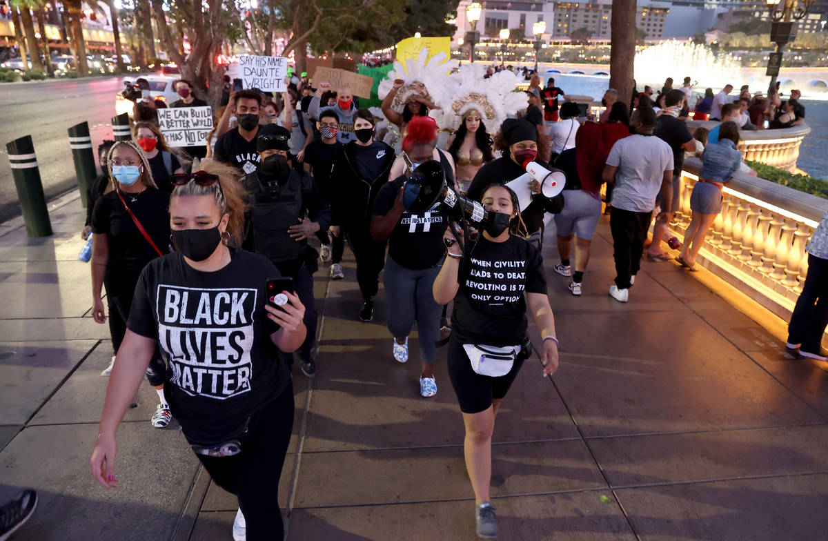 Protesters, including Leinati Hackley,, left, and Desiree Smith,of More Than A Hashtag, march a ...