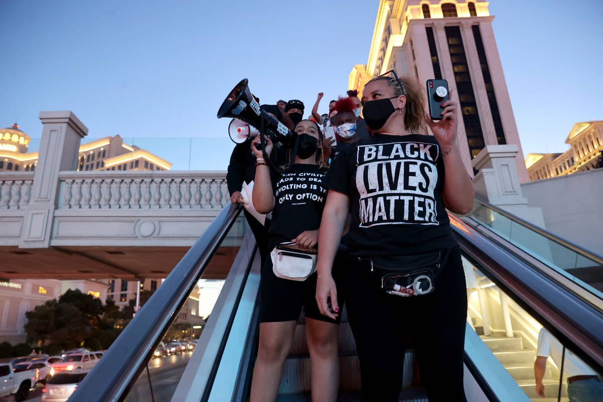 Protesters, including Desiree Smith, left, and Leinati Hackley, of More Than A Hashtag, march n ...