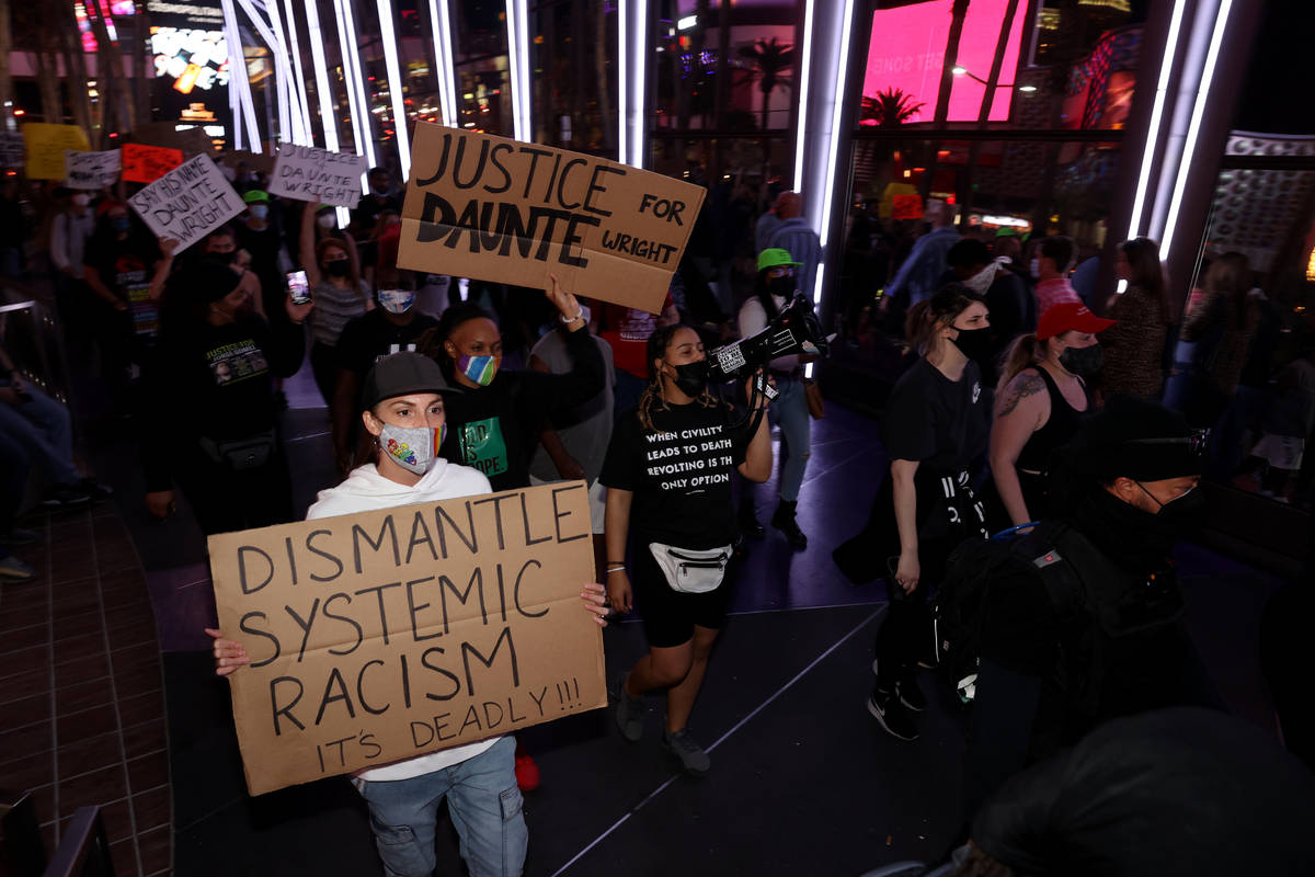 Protesters, including Maria Hayden of Las Vegas, left, march near the The Cosmopolitan of Las V ...