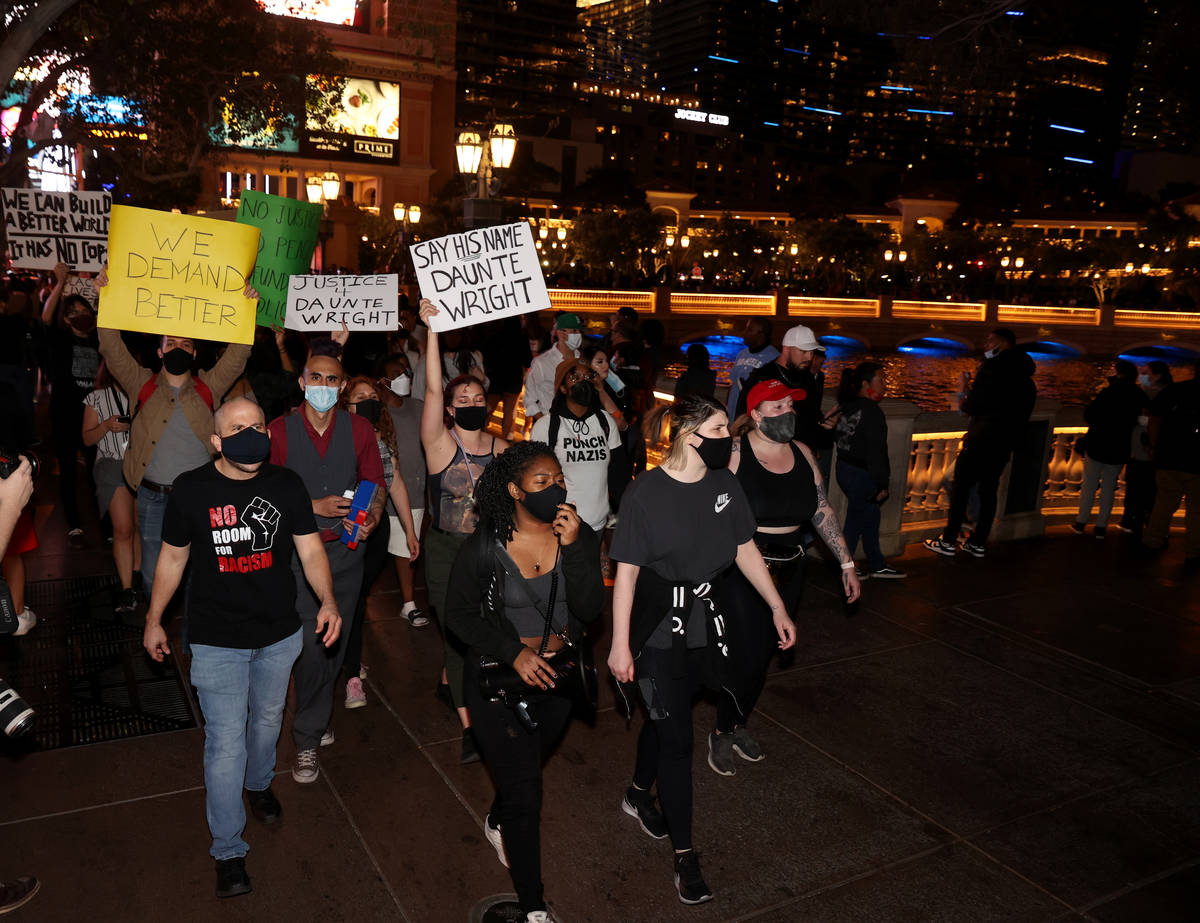 People protest at the Fountains of Bellagio on the Strip in Las Vegas Saturday, April 17, 2021, ...