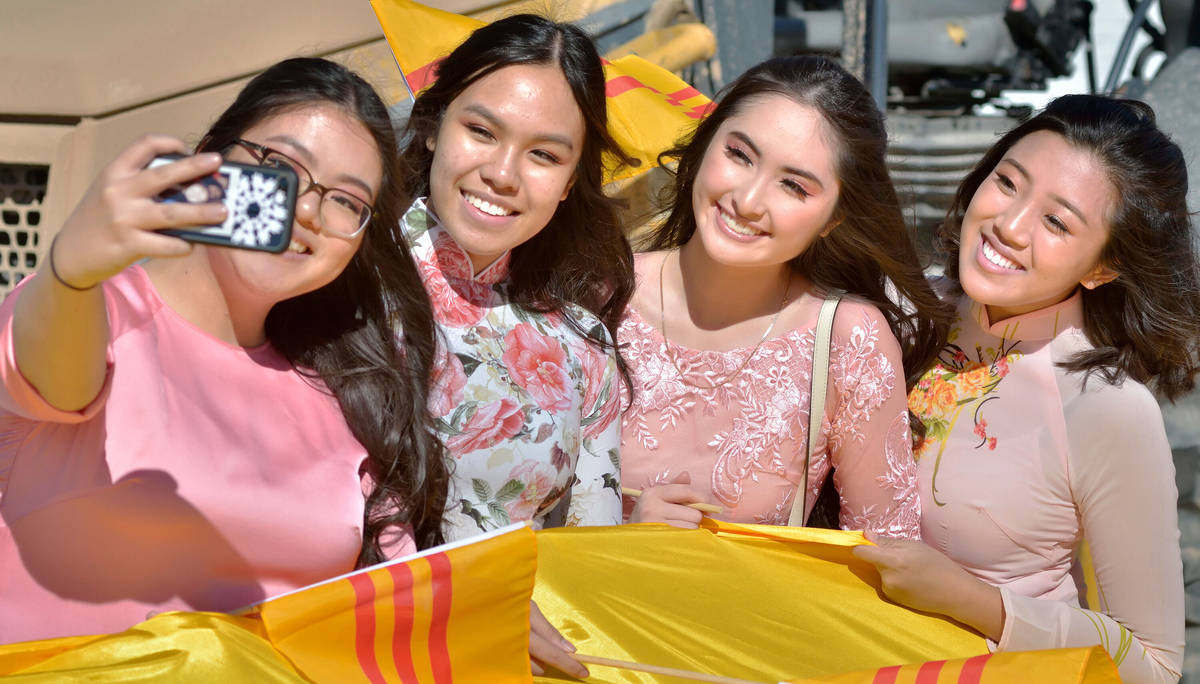 Kim Tran, 17, left, takes a picture with, from left, Kala Nguyen, 17, Jennele Nguyen, 17, and A ...