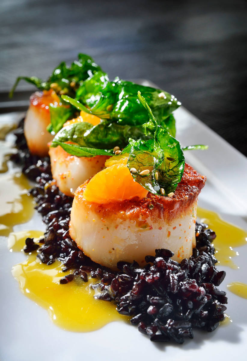 The Pan-seared Sea Scallops with Black Forbidden Rice is shown at Koi in the Planet Hollywood h ...