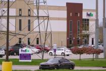 A sheriff's car blocks the entrance to the FedEx facility in Indianapolis, Saturday, April 17, ...
