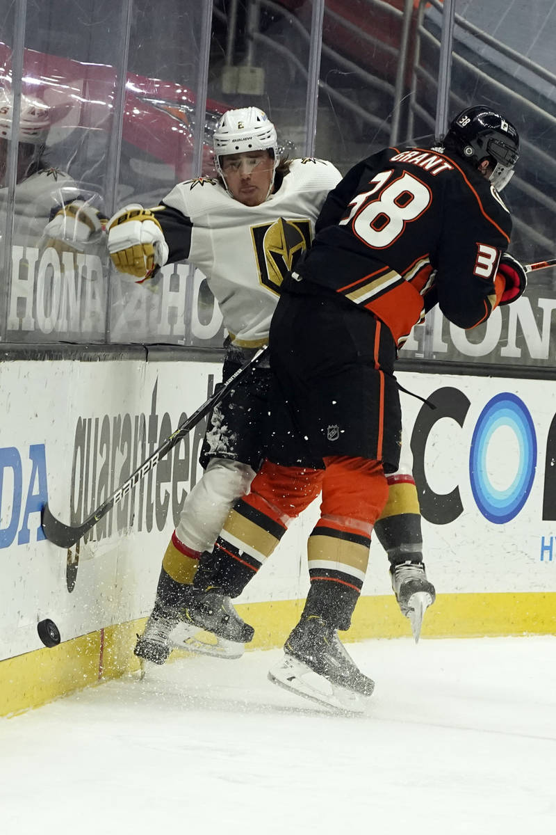 Vegas Golden Knights defenseman Zach Whitecloud, right, collides with Anaheim Ducks center Dere ...