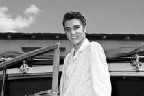 Elvis poses outside a car during his first run of shows at the New Frontier April 30, 1956, in ...