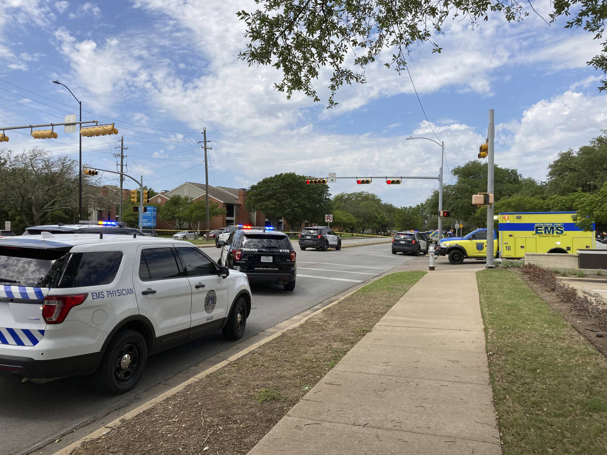 Police and emergency personnel work at the scene of a fatal shooting, Sunday, April 18, 2021, i ...