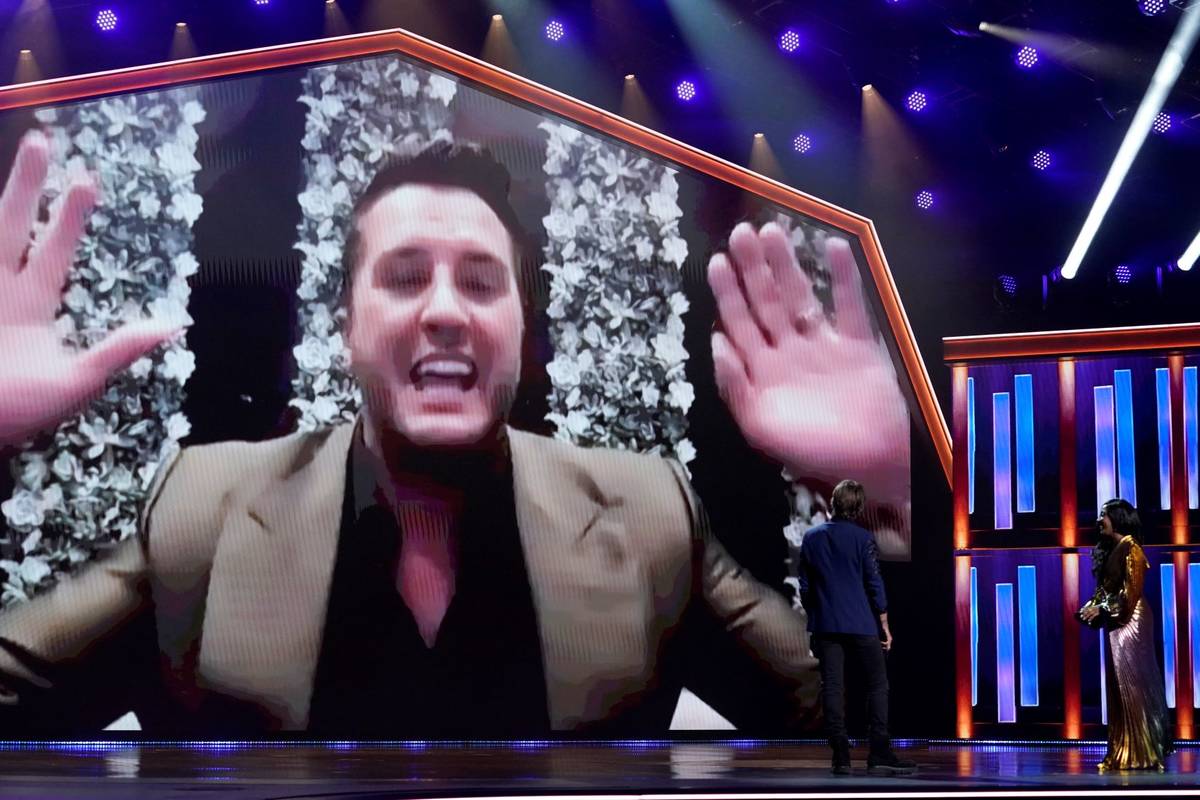 Luke Bryan appears on screen accepting the award for entertainer of the year at the 56th annual ...
