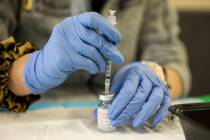 Touro University Nevada physician assistant student Madison Ginis extracts COVID-19 vaccines fr ...
