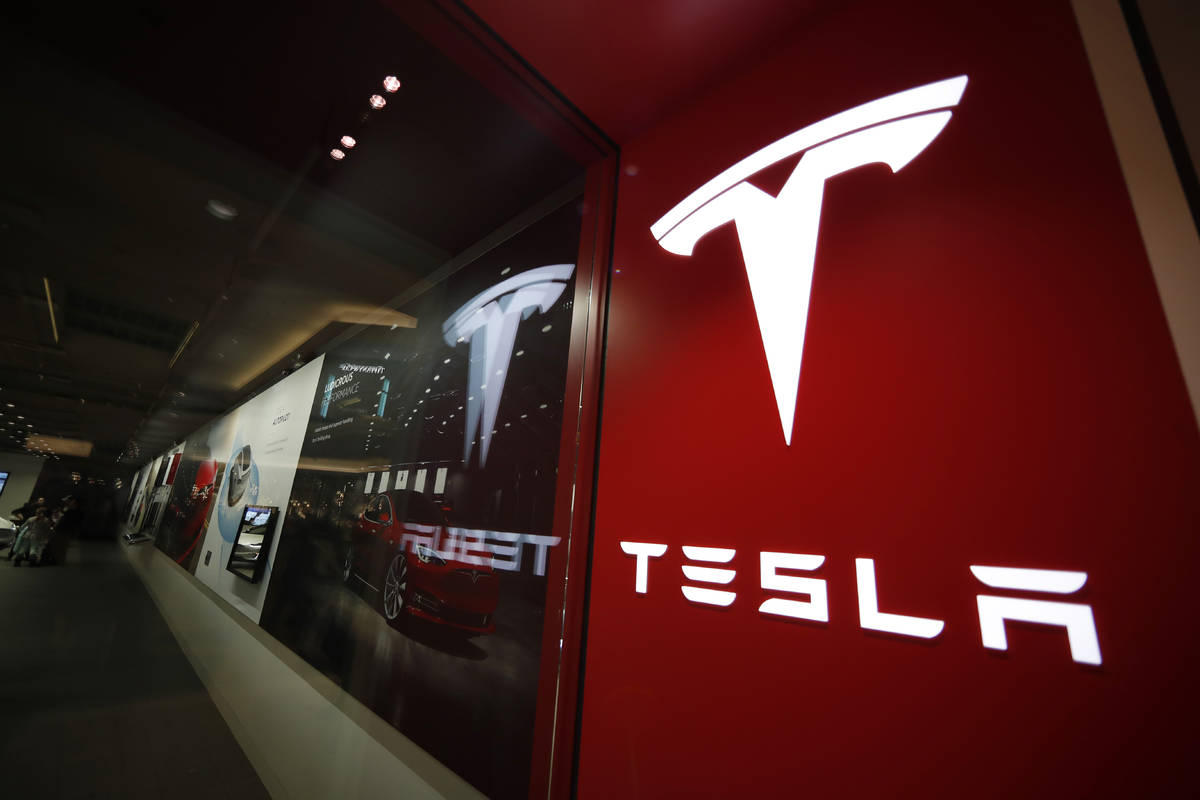 This Feb. 9, 2019, file photo shows a sign bearing the company logo outside a Tesla store in Ch ...