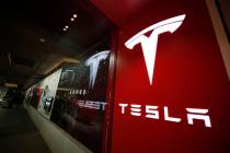 This Feb. 9, 2019, file photo shows a sign bearing the company logo outside a Tesla store in Ch ...