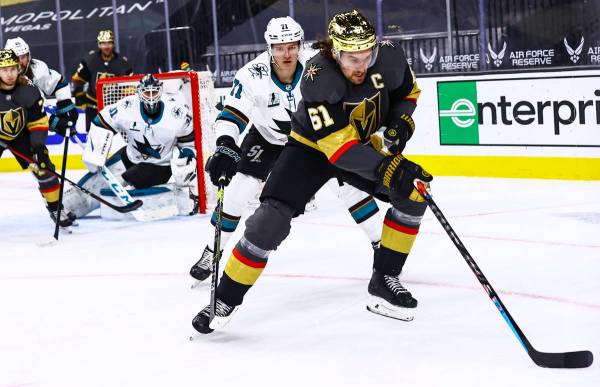 Golden Knights' Mark Stone (61) skates with the puck in front of San Jose Sharks' Nikolai Knyzh ...