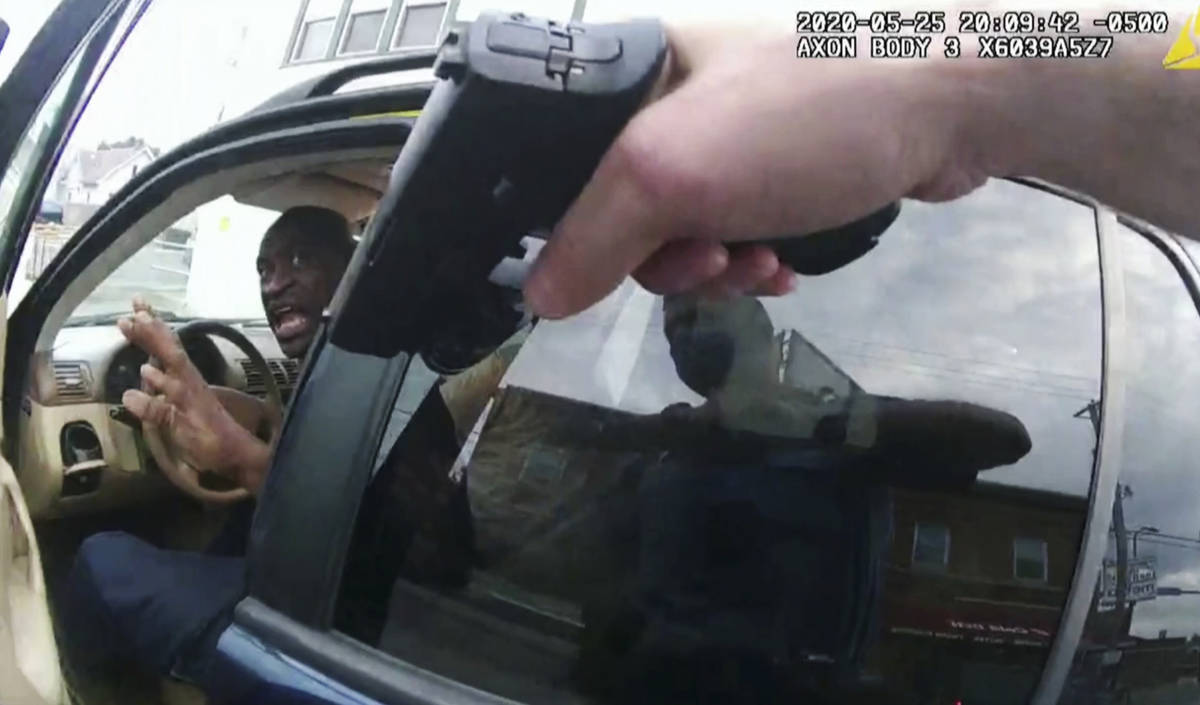 In this image from police body camera video George Floyd responds to police after they approach ...