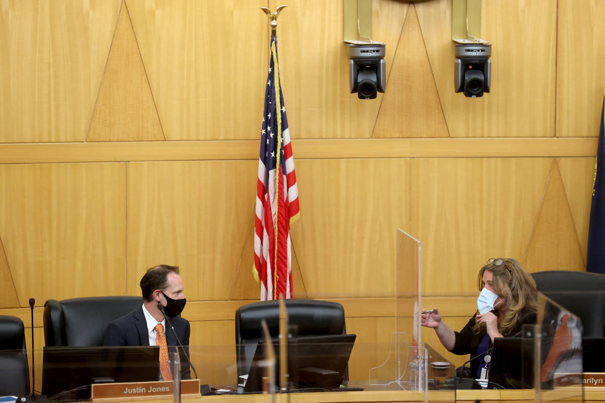 Clark County commissioners Justin Jones, left, and Chairman Marilyn Kirkpatrick talk before a c ...