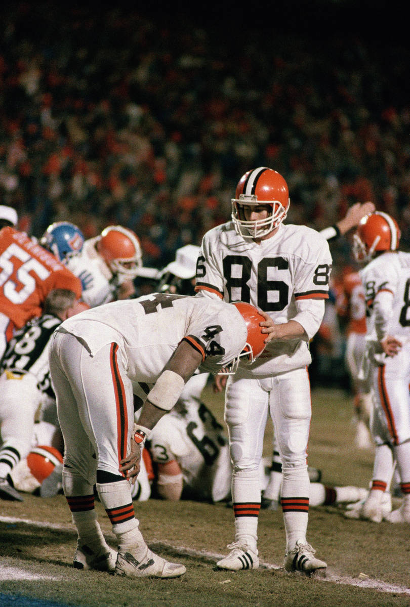 Cleveland running back Earnest Byner (44) is comforted by teammate Brian Brennan (86) after Byn ...
