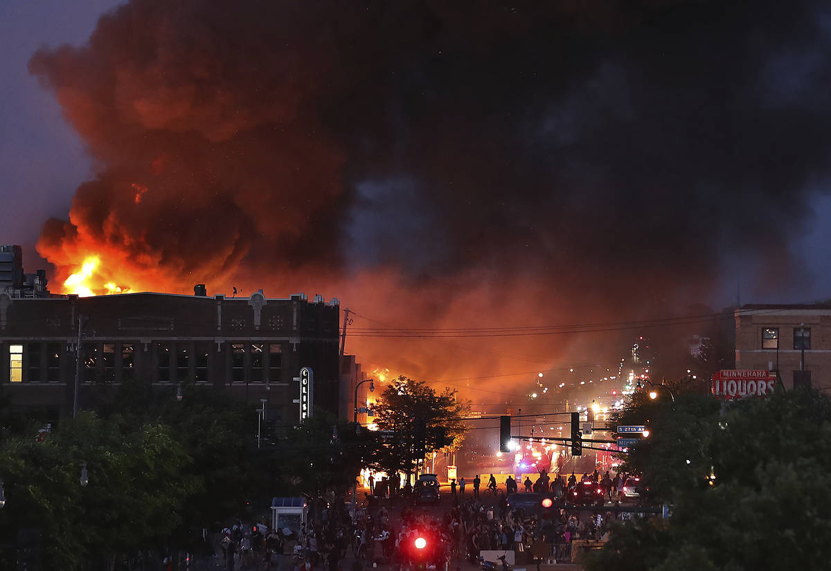 Seen from Hiawatha Avenue, a large fire burns Thursday, May 28, 2020, in Minneapolis during a t ...