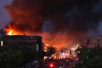 Seen from Hiawatha Avenue, a large fire burns Thursday, May 28, 2020, in Minneapolis during a t ...