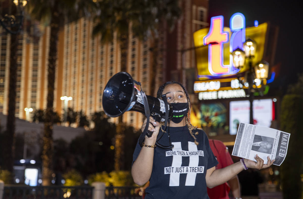 Organizer Desiree Smith talks to the small gathering before they leave the Venetian to march al ...