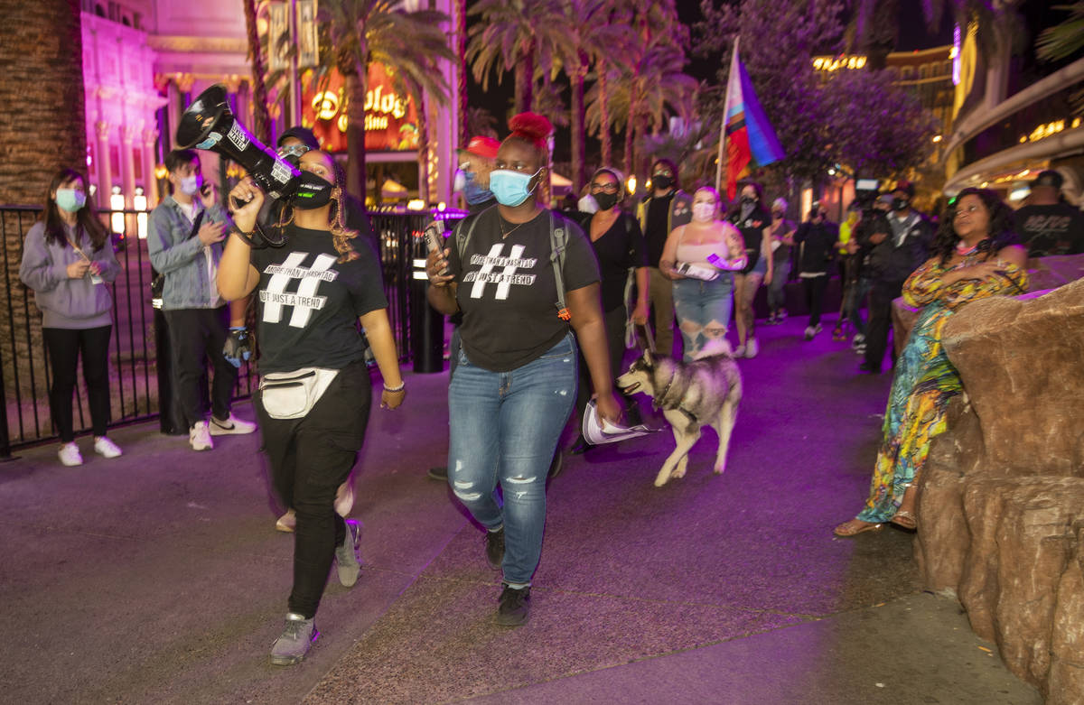Organizer Desiree Smith, left, and a small group march along the Strip following the conviction ...