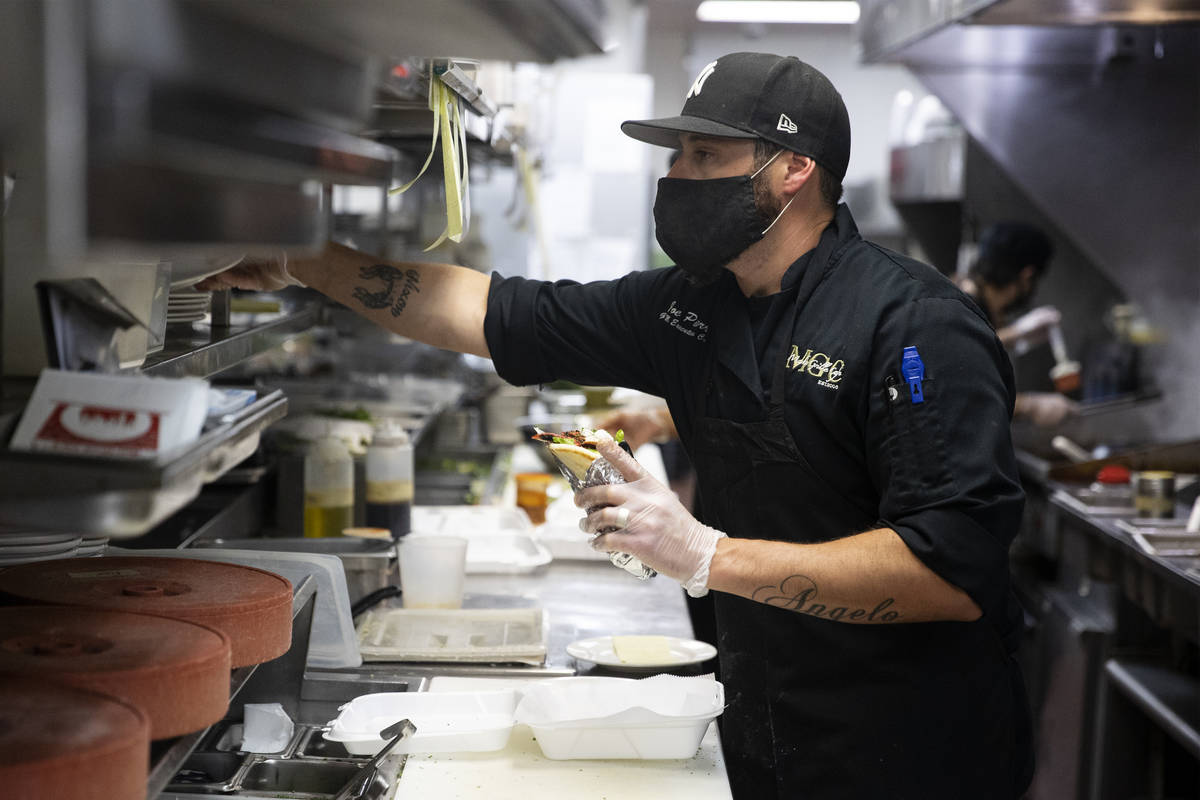 Joe Pierro Jr., the son of Market Grille Cafe owner Joe Pierro, works on an order during lunch ...