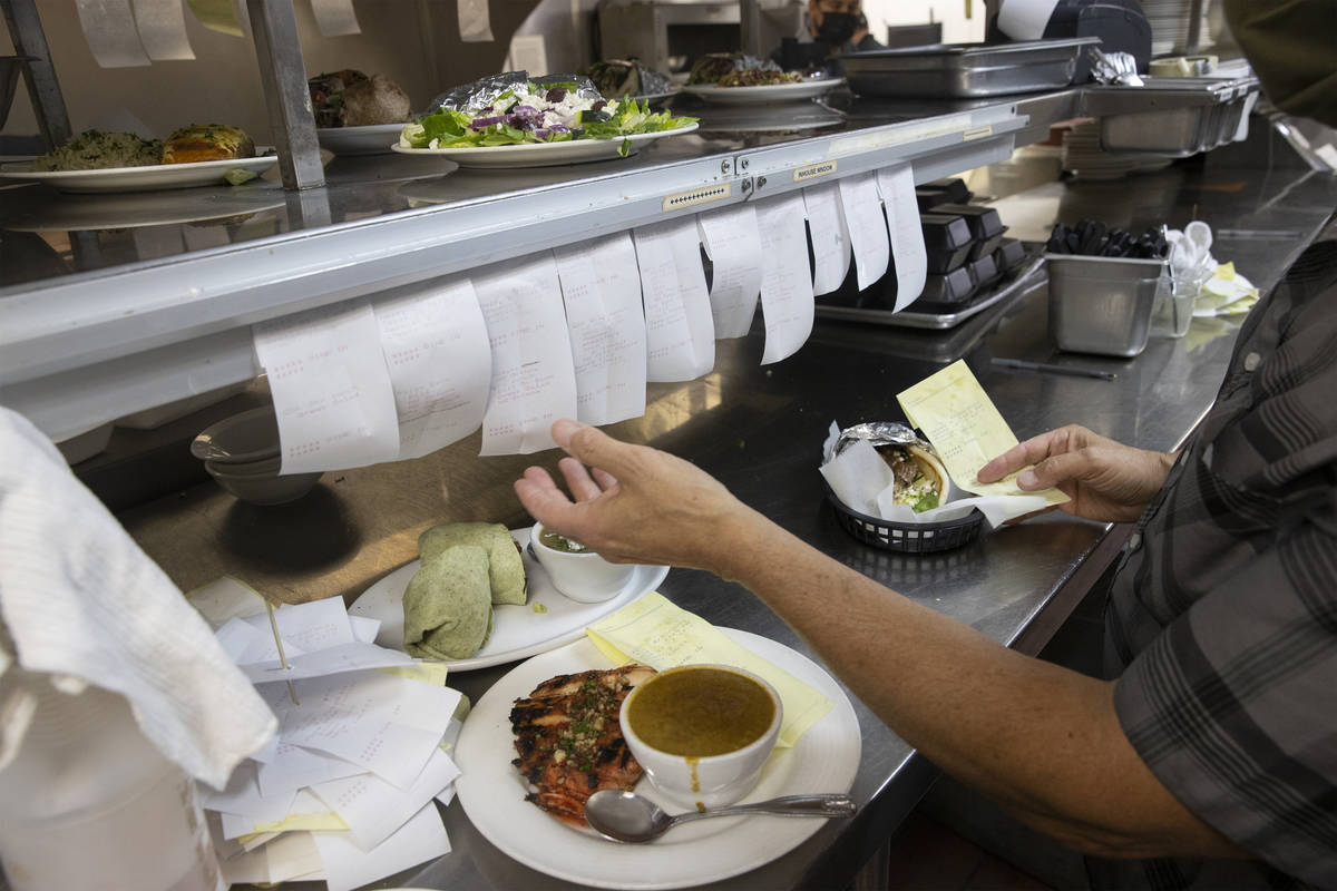 Joe Pierro, owner of Market Grille Cafe, lines up food tickets at his restaurant at 7070 N. Dur ...
