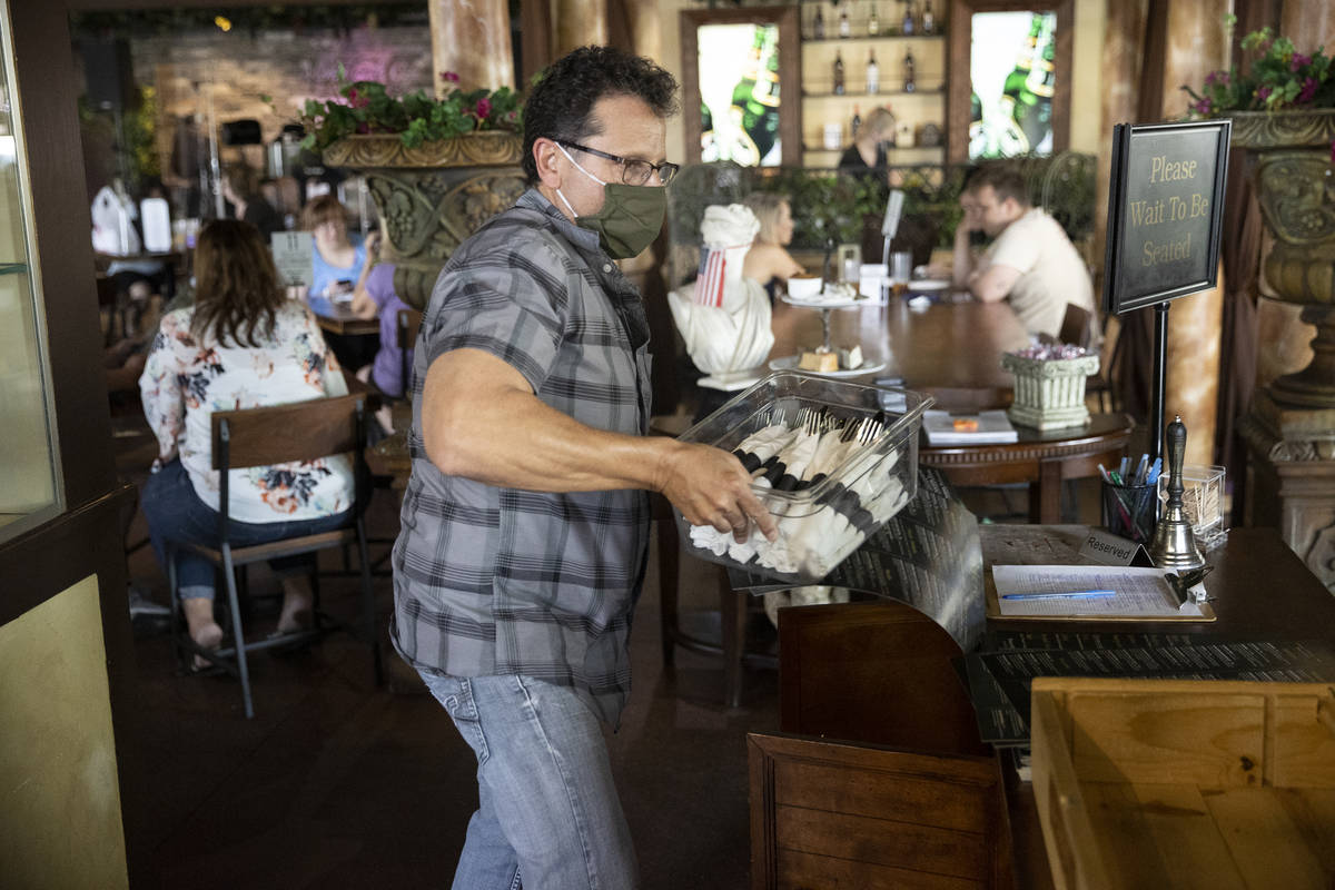 Joe Pierro, owner of Market Grille Cafe, works the host desk at his restaurant. Before the pand ...