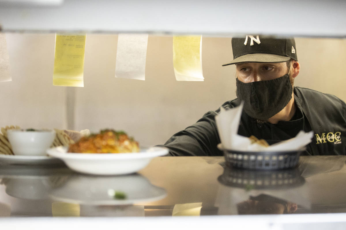 Joe Pierro Jr., the son of Market Grille Cafe owner Joe Pierro, sends out an order during lunch ...