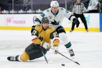 Vegas Golden Knights defenseman Shea Theodore (27) vies for the puck with San Jose Sharks right ...