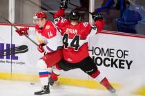 WHL player Bowen Byram fights for control of the puck with Russia's Maxim Marushev during secon ...