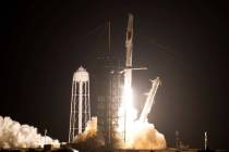 A SpaceX Falcon 9 rocket with the Crew Dragon space capsule lifts off from pad 39A at the Kenne ...