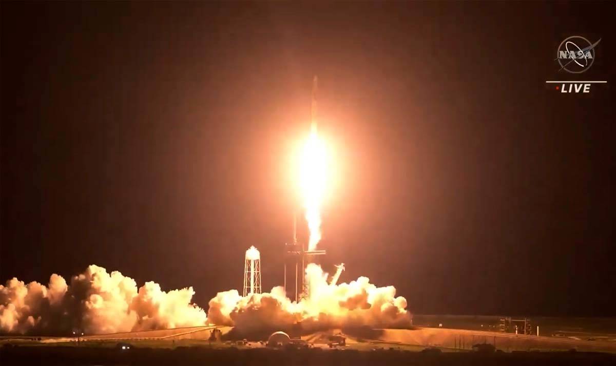 In this image made from NASA video, the SpaceX Crew Dragon spacecraft lifts off for the Crew-2 ...