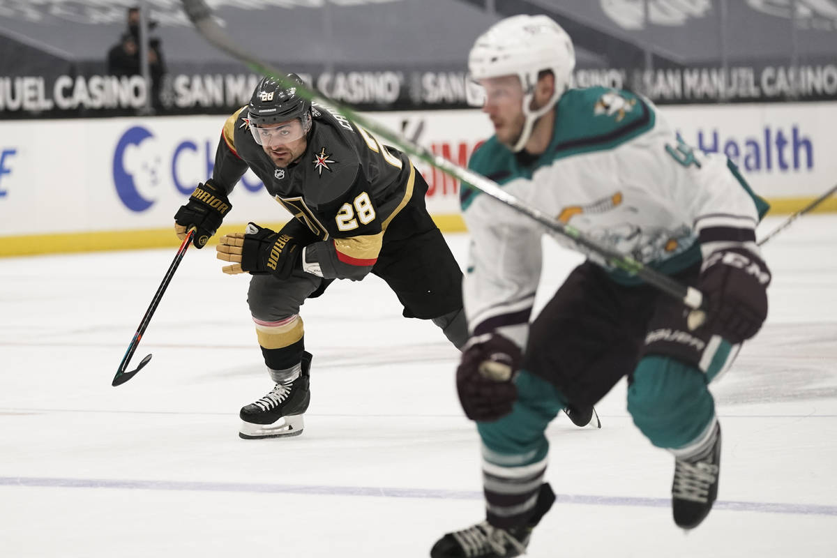 Vegas Golden Knights' William Carrier, left, and Anaheim Ducks' Andy Welinski, foreground, chas ...