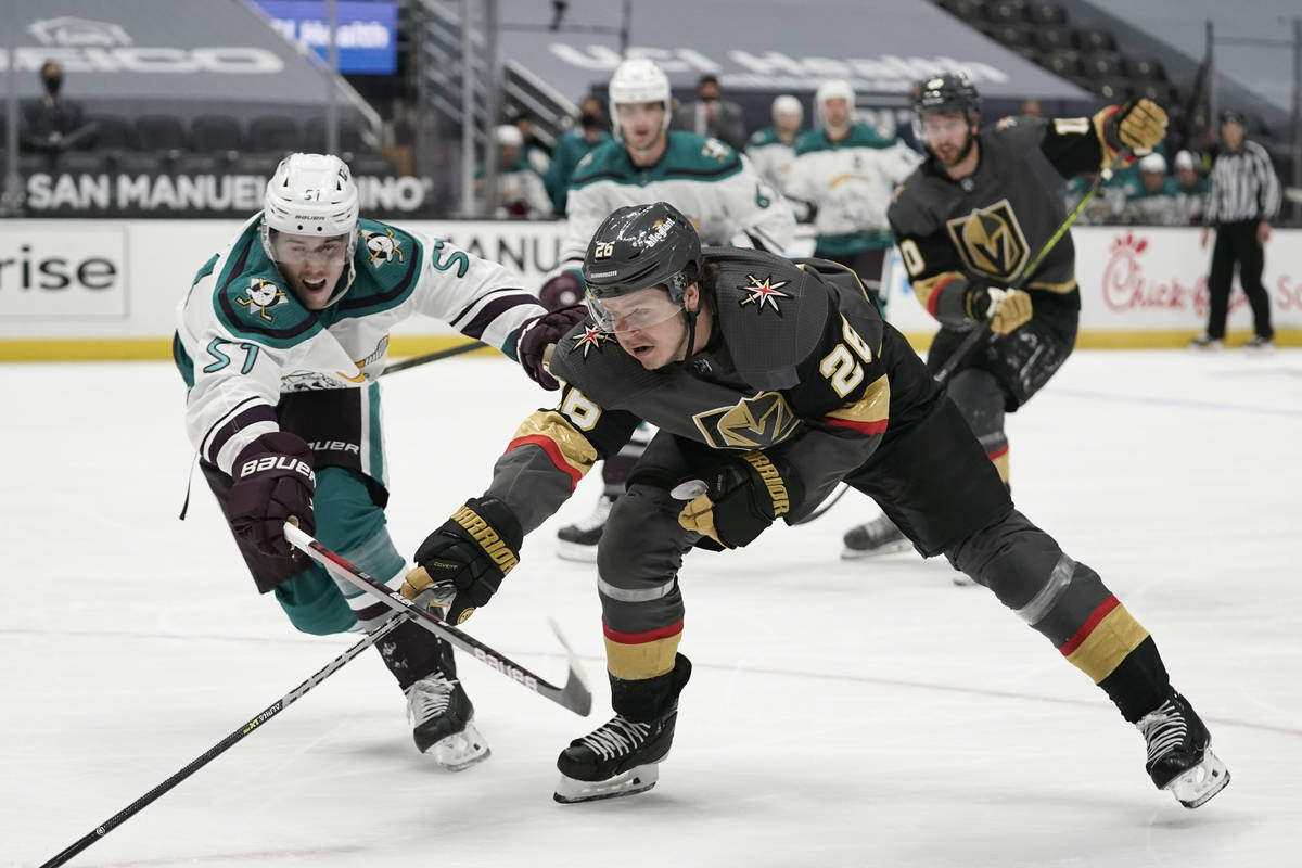 Vegas Golden Knights' Mattias Janmark, right, of Sweden, reaches for the puck under pressure by ...