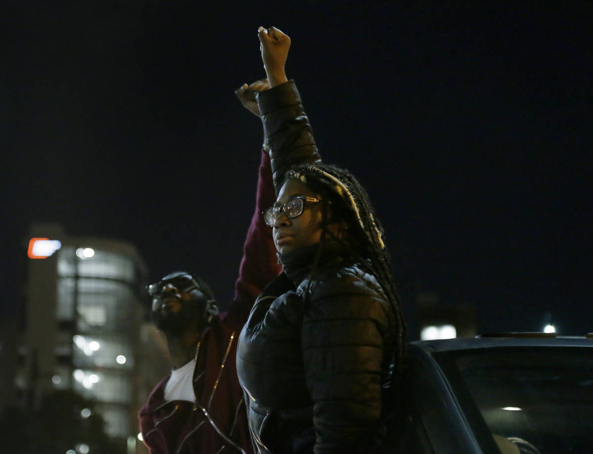 Demonstrators take part in a protest in downtown Columbus, Ohio, Wednesday night, April 21, 202 ...