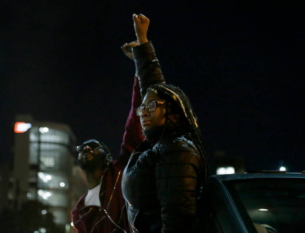 Demonstrators take part in a protest in downtown Columbus, Ohio, Wednesday night, April 21, 202 ...