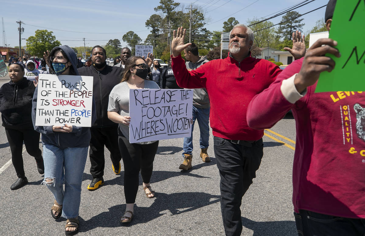 Kirk Rivers leads a group of demonstrators as they block Ehringhaus Street, a main retail avenu ...
