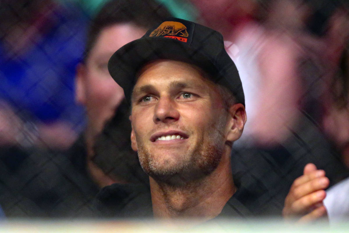 Tampa Bay Buccaneers quarterback Tom Brady watches a UFC 261 mixed martial arts bout, Saturday, ...